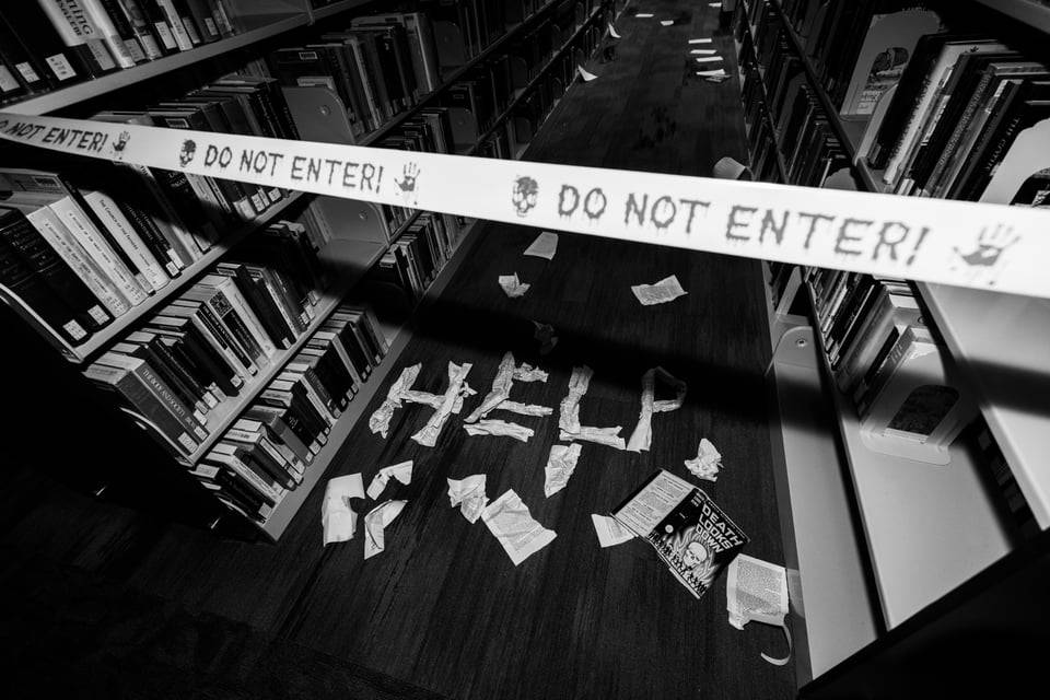 Caution tape with "help" written on the floor